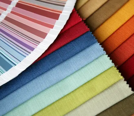 A close up of several different colored fabrics